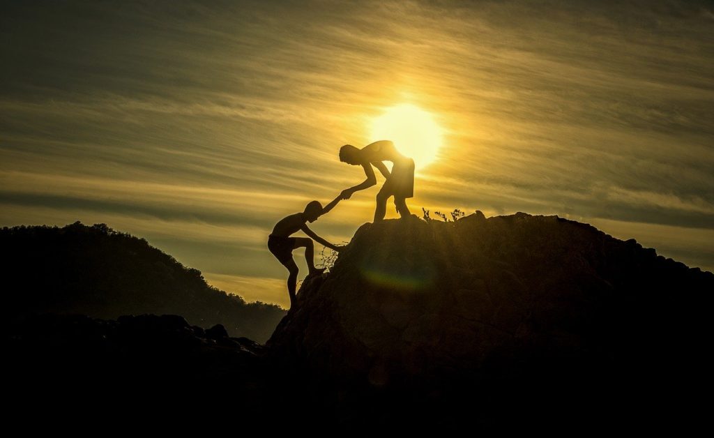 climbing a mountain reach your goals with life coaching
